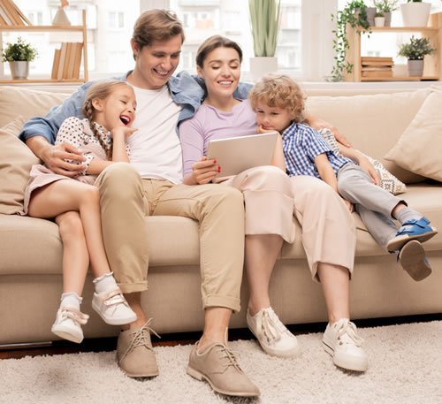 Smiling family enjoying peace of mind in their home after professional mold testing and remediation